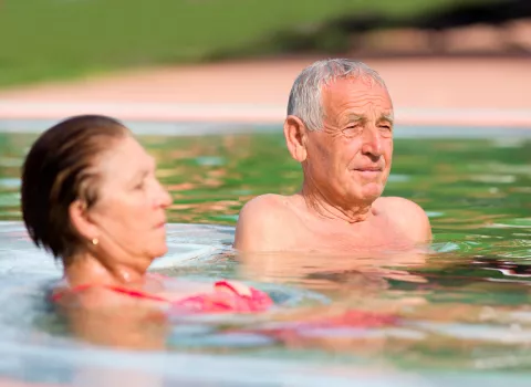 Personas mayores tomando un baño en agua de mar