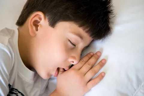 Niño chupándose el dedo mientras duerme