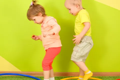 Dos niños pequeños juegan a un juego que implica actividad física