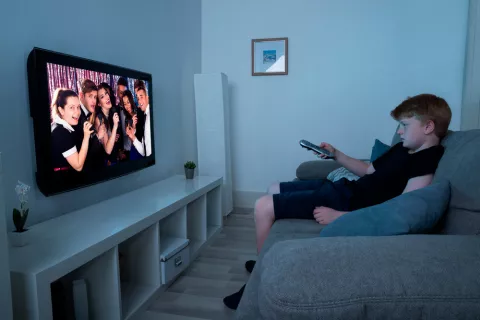 Niño viendo la televisión en el salón de su casa